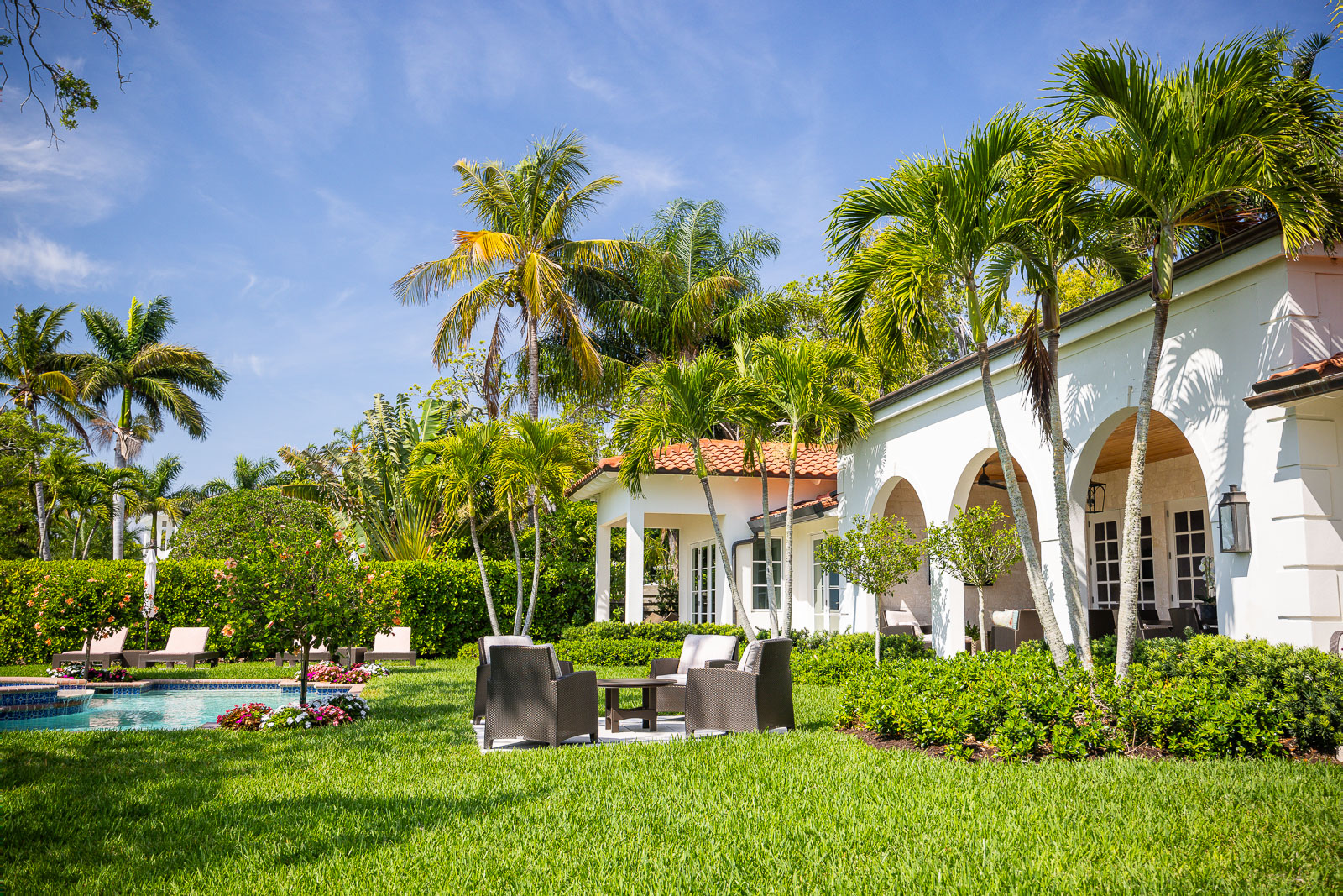 Mature palms and shade trees framing an established Florida garden