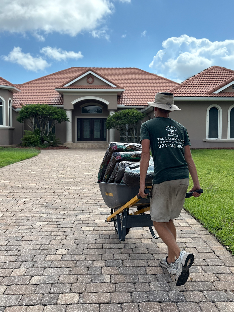 A TSL crew member delivering landscape materials to a client's home